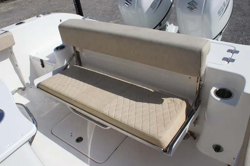 Slide: The Image of 2023 Sea Pro 259 Deep V CC boat with beige cushioned seating and dual Suzuki engines. - 7