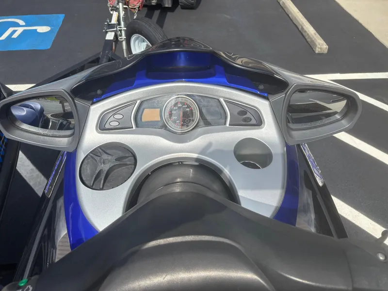 Slide: The Image of 2006 Yamaha WaveRunner FX HO dashboard with mirrors and speedometer, parked on asphalt. - 5