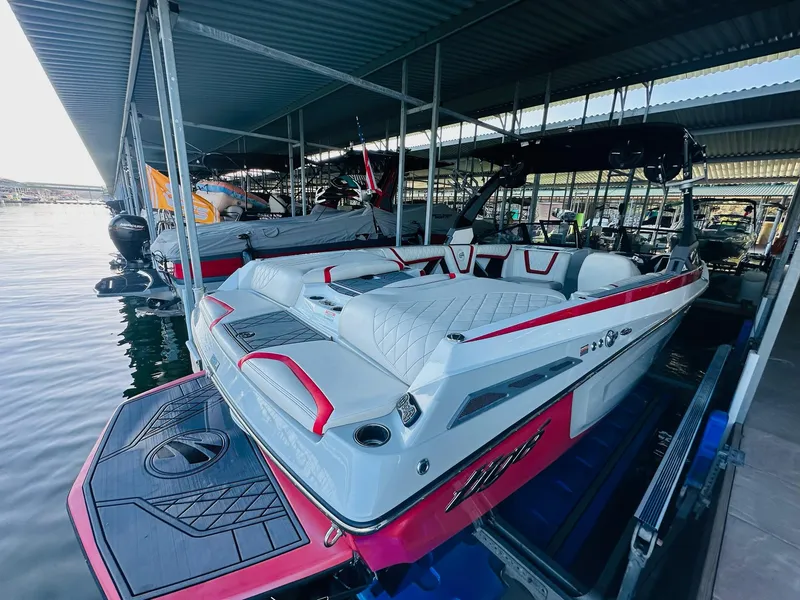 Slide: The Image of 2020 Tigé 25ZX boat docked, featuring sleek design and red accents. - 13