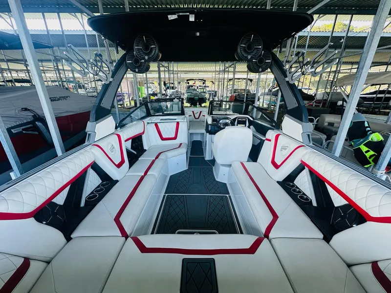 Slide: The Image of 2020 Tigé 25ZX boat interior with white and red seating, advanced dashboard, and spacious layout. - 15