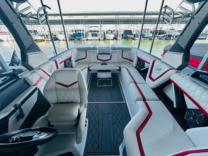 Slide: The Image of Luxurious interior of 2020 Tigé 25ZX boat with white and red seating. - 17
