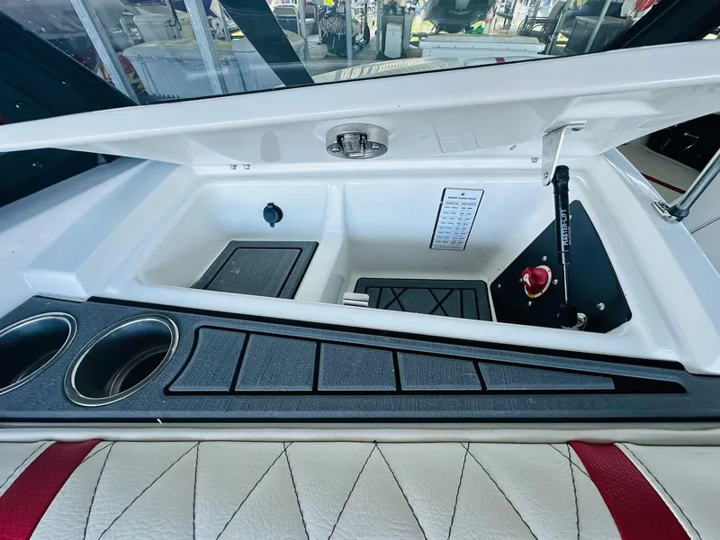Slide: The Image of 2020 Tigé 25ZX boat storage compartment with cup holders and hydraulic lift. - 23