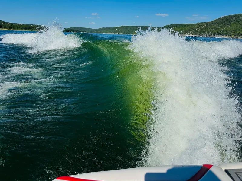 Slide: The Image of Wake created by a 2020 Tigé 25ZX boat on a sunny lake. - 25