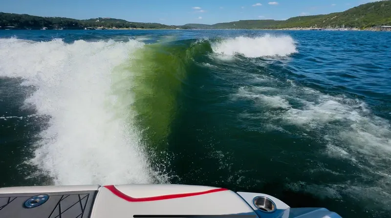 Slide: The Image of Wake created by a 2020 Tigé 25ZX boat on a scenic lake. - 26
