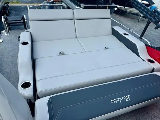 Slide: The Image of 2026 Barletta C24UC boat interior with gray seating and cup holders. - 11