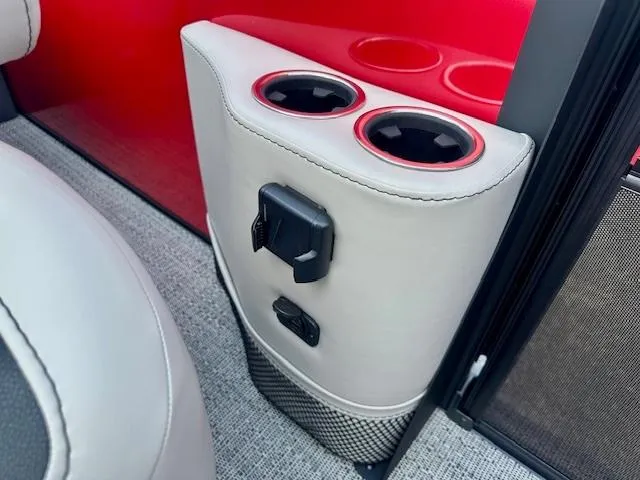 Slide: The Image of Barletta C24UC 2026 interior with cup holders and charging port, featuring red and gray accents. - 12