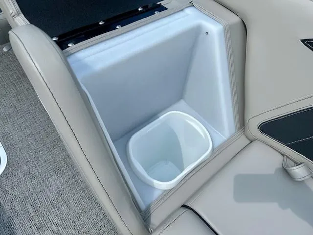 Slide: The Image of Built-in storage compartment on 2026 Barletta C24UC boat with gray upholstery. - 15
