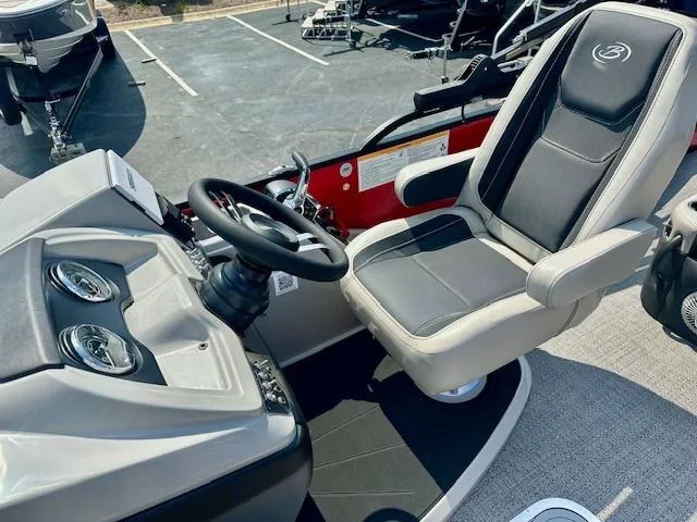 Slide: The Image of Captain's seat and helm of 2026 Barletta C24UC pontoon boat. - 5