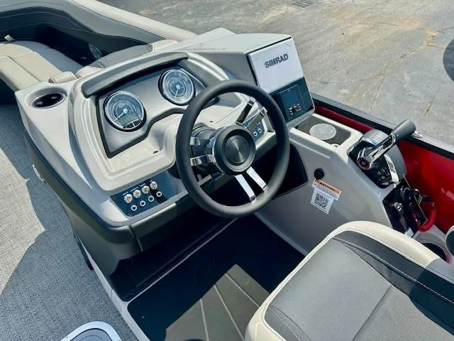 Slide: The Image of 2026 Barletta C24UC boat dashboard with steering wheel and control panel. - 6