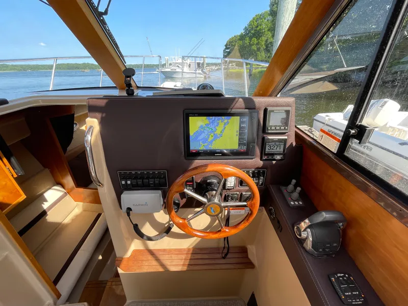Slide: The Image of Interior view of 2017 Cutwater C-28 boat cockpit with navigation system and steering wheel. - 13