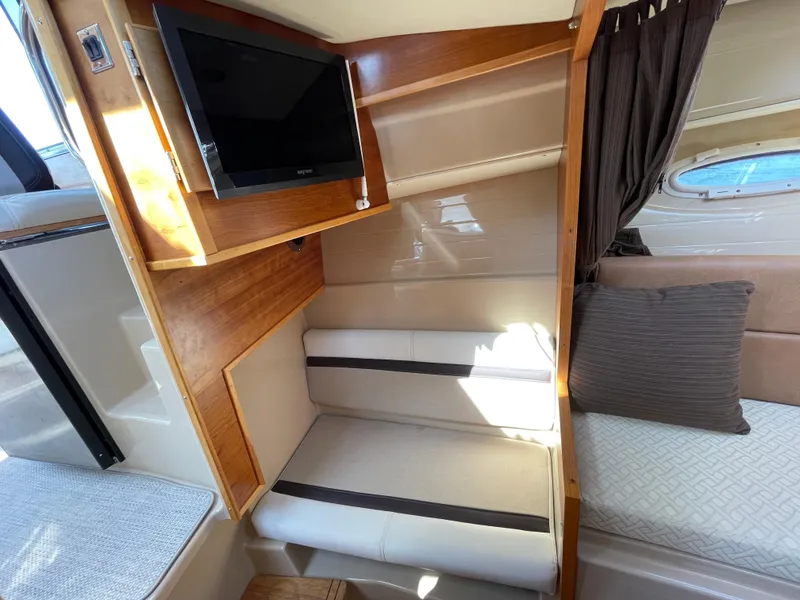 Slide: The Image of 2017 Cutwater C-28 interior with TV, seating, and window view. - 18