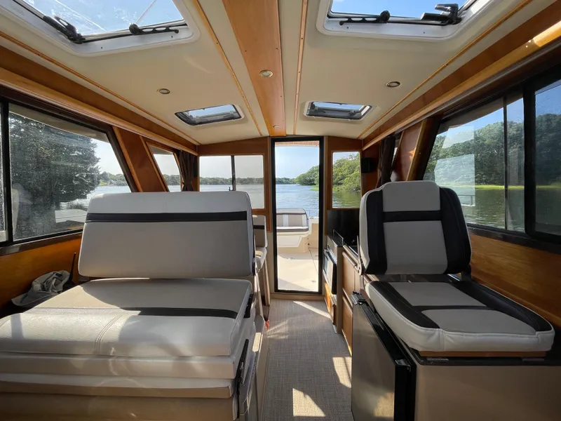Slide: The Image of Interior of 2017 Cutwater C-28 boat with seating, windows, and scenic water view. - 19