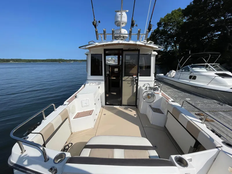Slide: The Image of 2017 Cutwater C-28 boat docked, featuring spacious deck and modern design. - 4