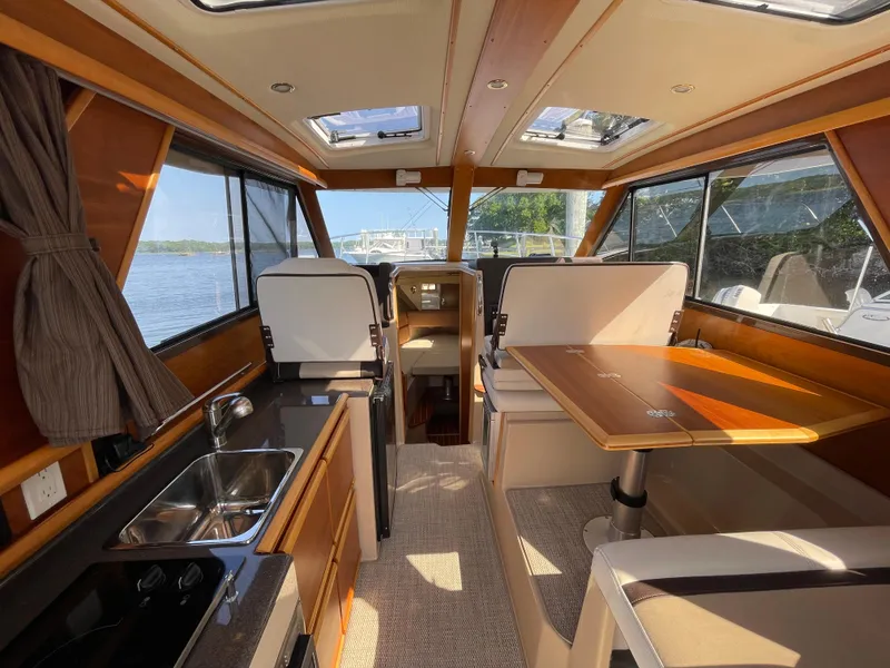 Slide: The Image of Interior of 2017 Cutwater C-28 boat with dining area and kitchenette. - 9