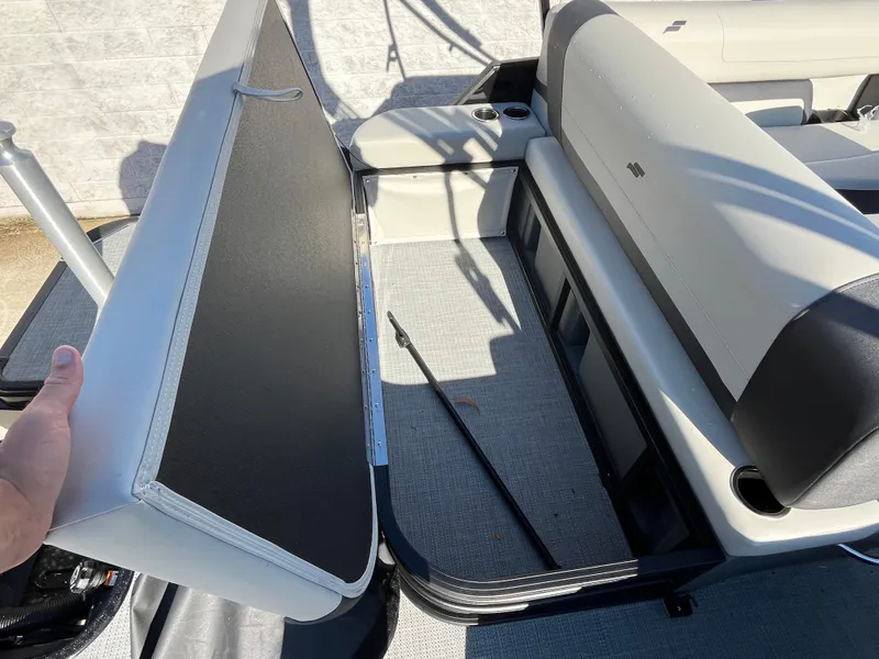 Slide: The Image of 2025 Starcraft EXS-3 boat interior with open storage compartment and seating area. - 10