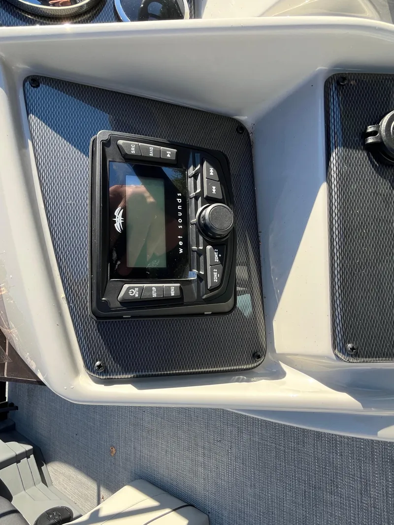 Slide: The Image of 2025 Starcraft EXS-3 boat dashboard with audio control panel. - 20