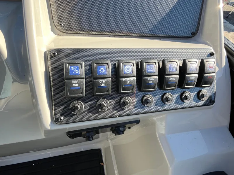 Slide: The Image of Control panel of 2025 Starcraft EXS-3 boat with labeled switches and dials. - 22