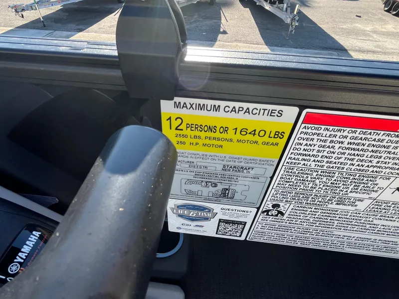 Slide: The Image of Starcraft EXS-3 2025 boat capacity label, showing limits of 12 persons or 1640 lbs. - 24