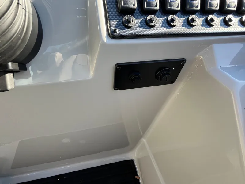 Slide: The Image of Control panel of 2025 Starcraft EXS-3 boat with switches and connectors. - 25