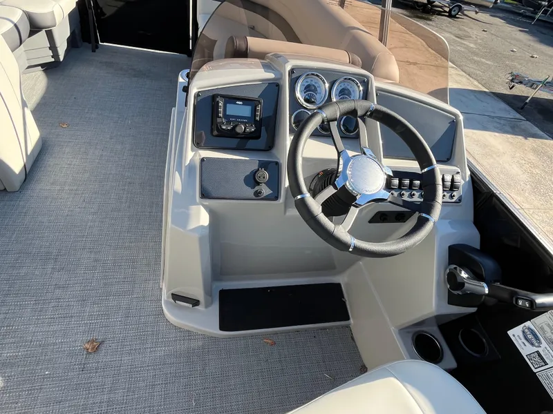 Slide: The Image of 2025 Starcraft EXS-3 boat dashboard with steering wheel and control panel. - 26