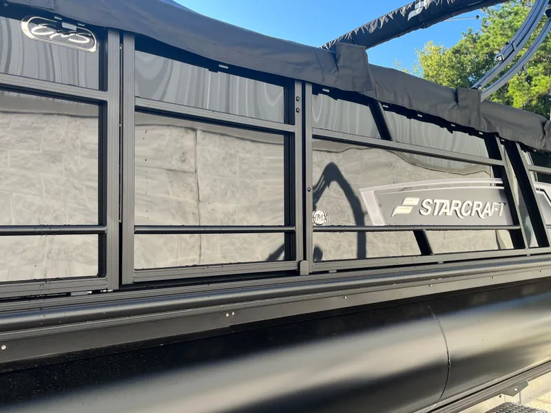 Slide: The Image of 2025 Starcraft EXS-3 boat side view with logo and sleek black design. - 36