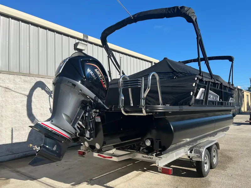 Slide: The Image of 2025 Starcraft EXS-3 boat on trailer, featuring a powerful outboard motor. - 5