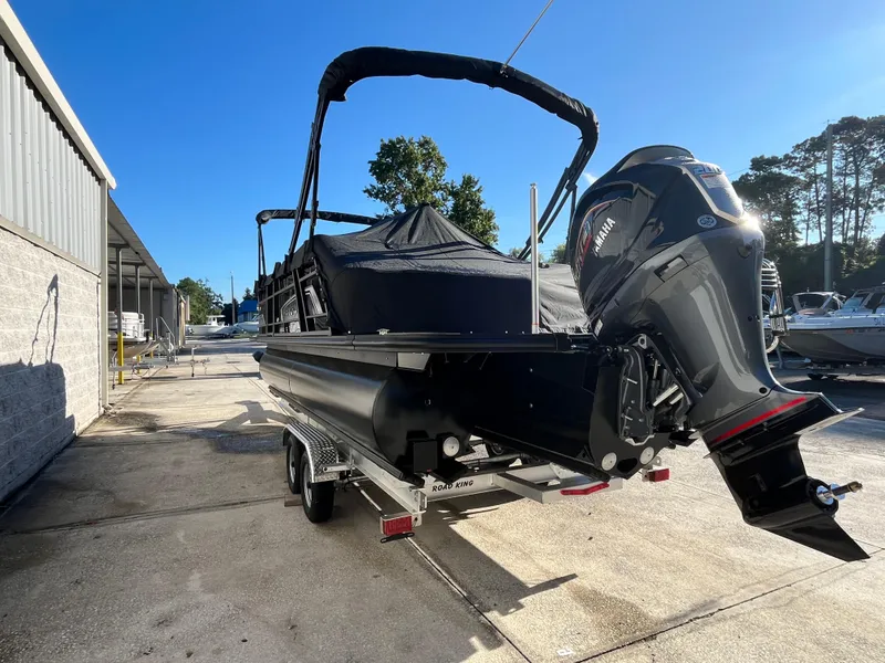 Slide: The Image of 2025 Starcraft EXS-3 boat with Yamaha engine on trailer, parked outdoors. - 6