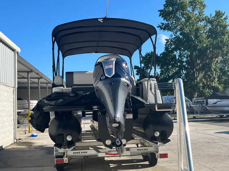 Slide: The Image of 2025 Starcraft EXS-3 boat on trailer, parked outdoors under clear blue sky. - 7