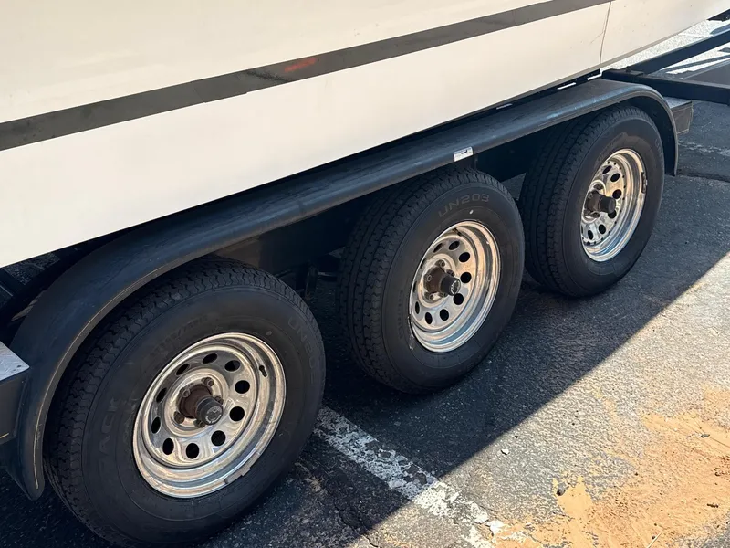 Slide: The Image of Triple-axle trailer for 2001 Sea Ray 270 Sundancer boat on pavement. - 10