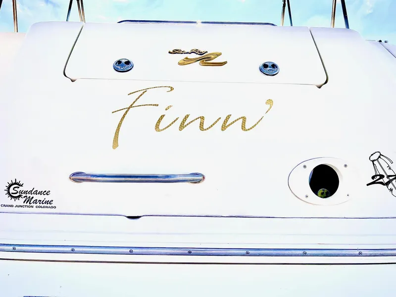 Slide: The Image of 2001 Sea Ray 270 Sundancer boat named "Finn" with Sundance Marine logo. - 12