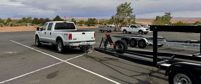 Slide: The Image of White truck towing Sea Ray 270 Sundancer trailer in parking lot, 2001 model. - 13