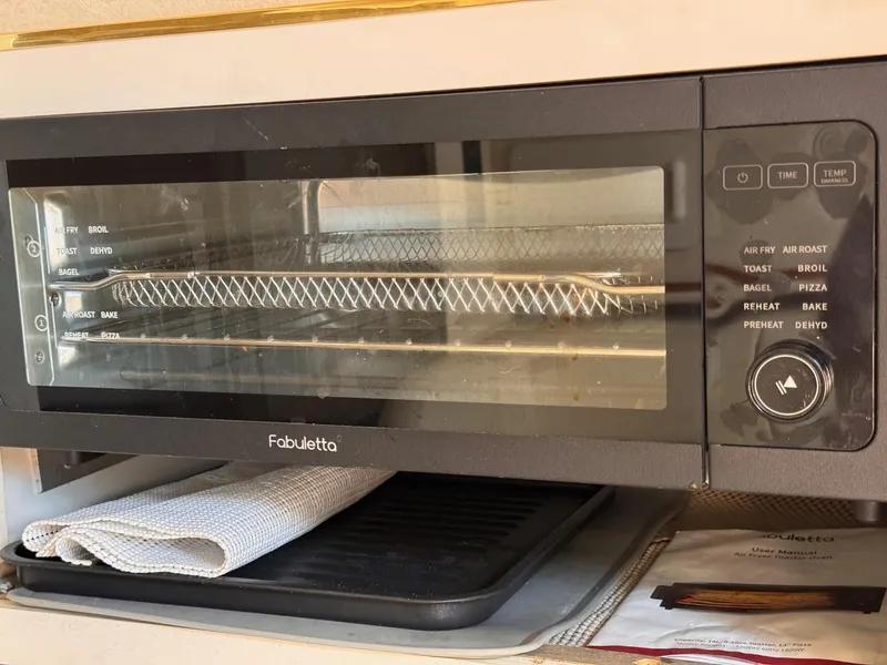 Slide: The Image of Modern Fabuletta toaster oven with multiple cooking functions, including air fry and broil. - 14