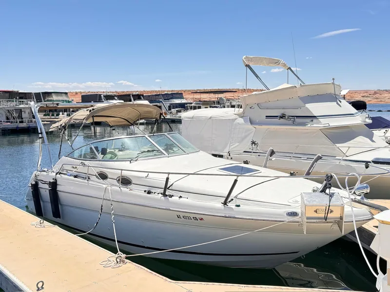 Slide: The Image of 2001 Sea Ray 270 Sundancer docked at marina under clear blue sky. - 2