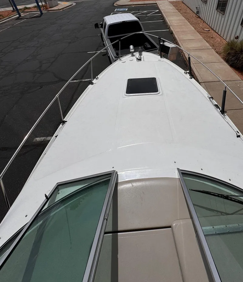 Slide: The Image of 2001 Sea Ray 270 Sundancer boat on trailer, parked in a lot. - 22