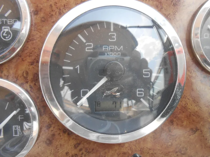 Slide: The Image of Close-up of a 2001 Sea Ray 270 Sundancer RPM gauge on a wooden dashboard. - 27