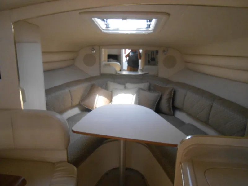 Slide: The Image of Interior of 2001 Sea Ray 270 Sundancer with cozy seating and table. - 28