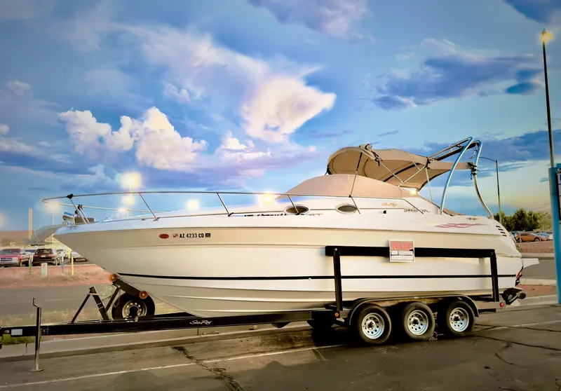 Slide: The Image of 2001 Sea Ray 270 Sundancer boat on trailer under a vibrant sky. - 4