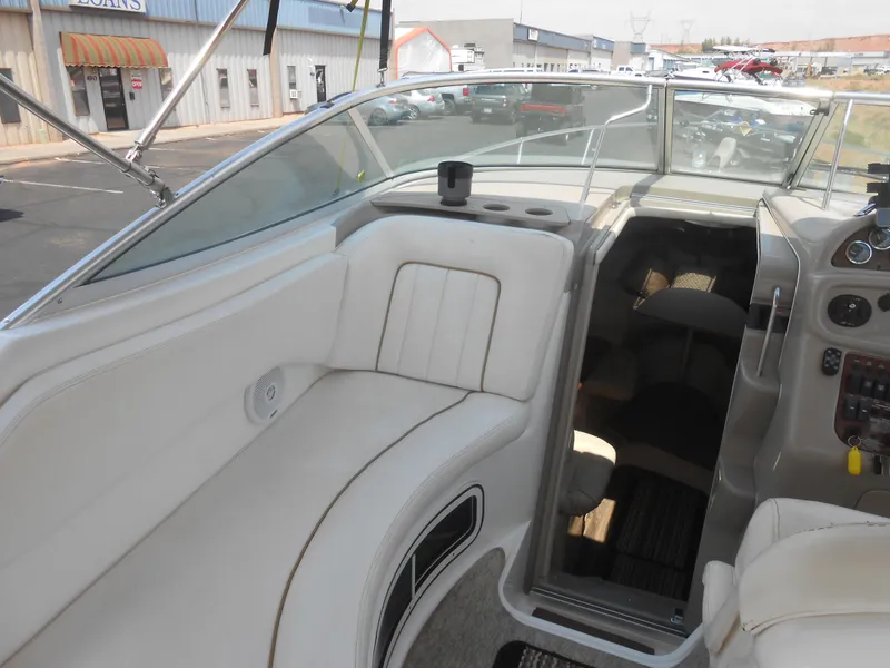 Slide: The Image of 2001 Sea Ray 270 Sundancer interior with white seating and dashboard controls. - 40