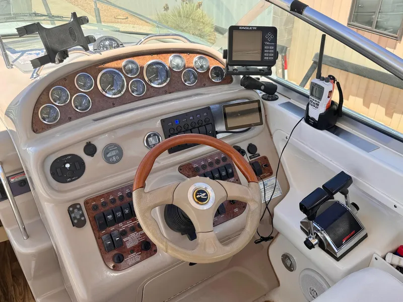 Slide: The Image of Cockpit of 2001 Sea Ray 270 Sundancer with steering wheel, gauges, and navigation equipment. - 7