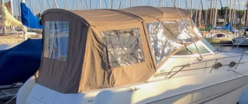 Slide: The Image of 2001 Sea Ray 270 Sundancer boat with brown canopy docked at marina. - 9