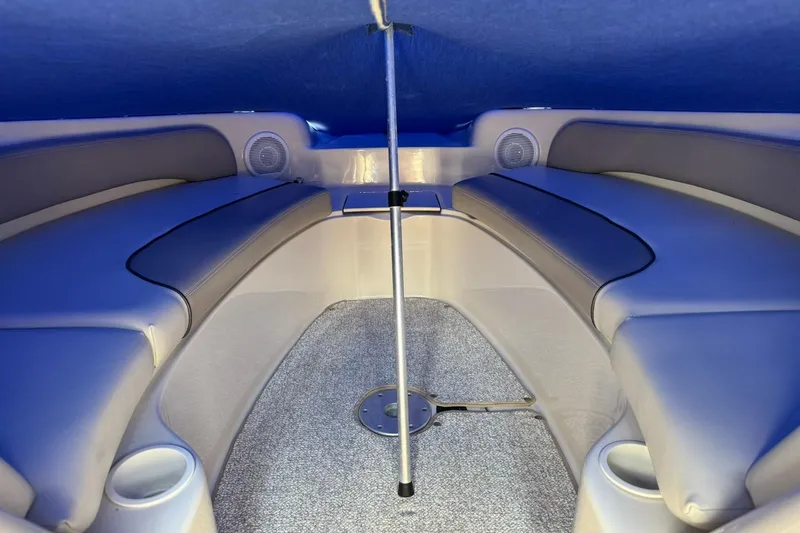 Slide: The Image of Interior of 2002 Sea Ray 240 Sundeck boat with cushioned seating and cup holders. - 10