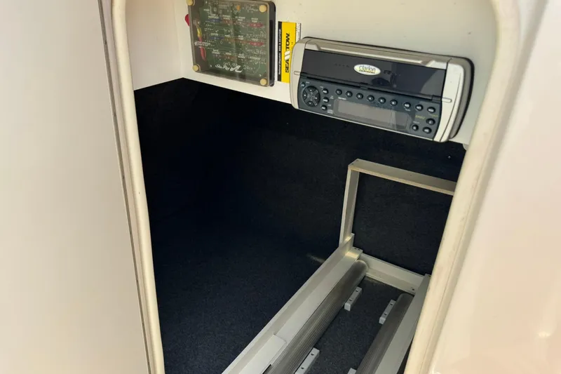 Slide: The Image of 2002 Sea Ray 240 Sundeck interior with stereo system and fuse panel. - 11