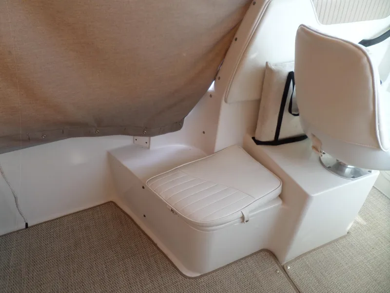 Slide: The Image of 2005 Seaswirl Striper boat interior with white seating and beige carpet. - 11