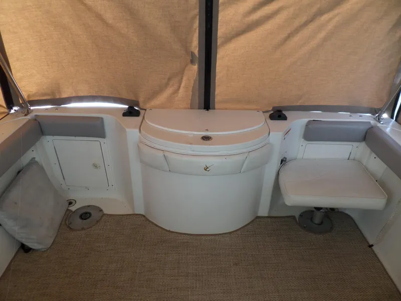 Slide: The Image of 2005 Seaswirl Striper boat interior with seating and storage compartments. - 13