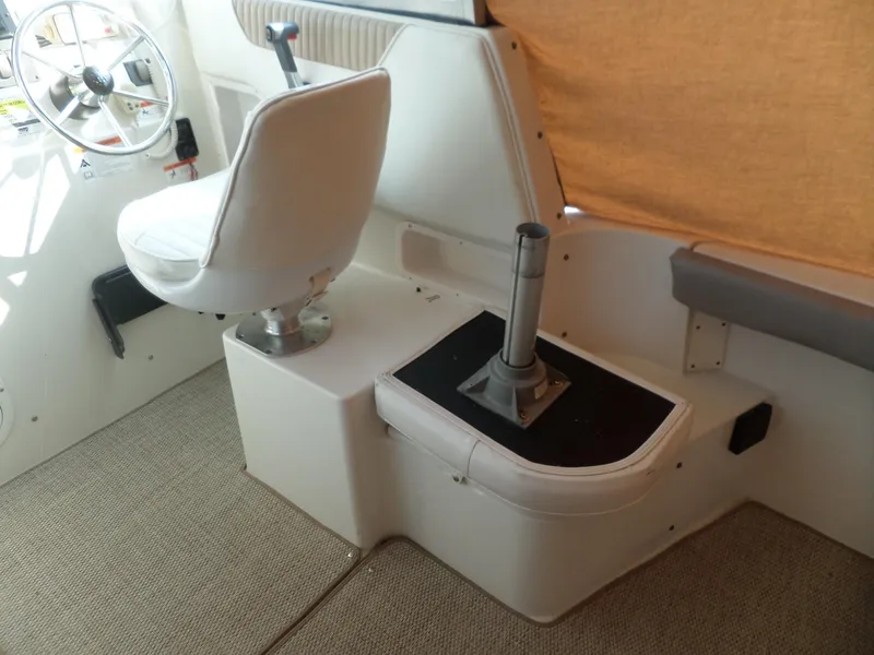 Slide: The Image of 2005 Seaswirl Striper boat interior with captain's chair and steering wheel. - 16