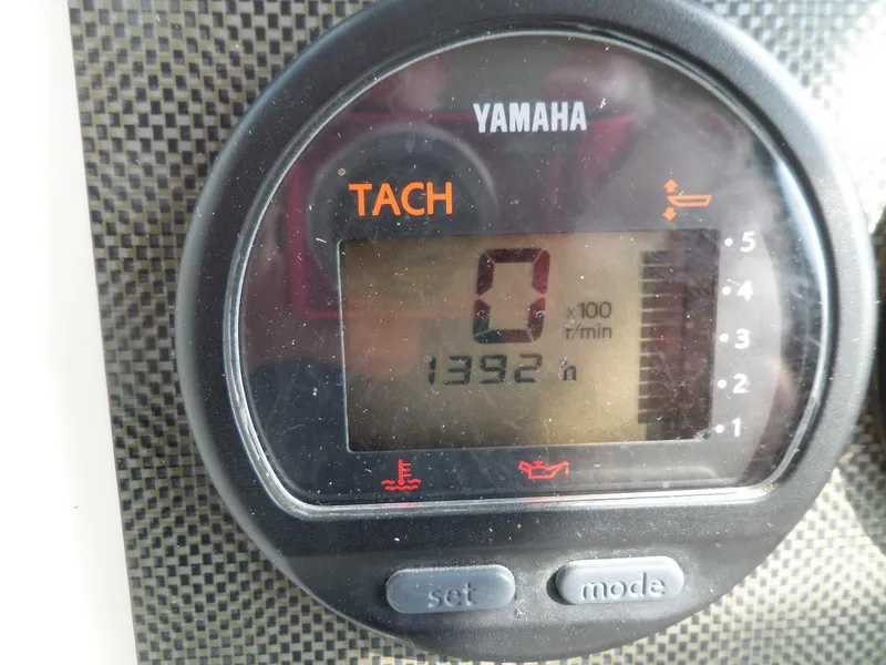 Slide: The Image of Yamaha tachometer on 2005 Seaswirl Striper boat, displaying 1392 hours. - 18
