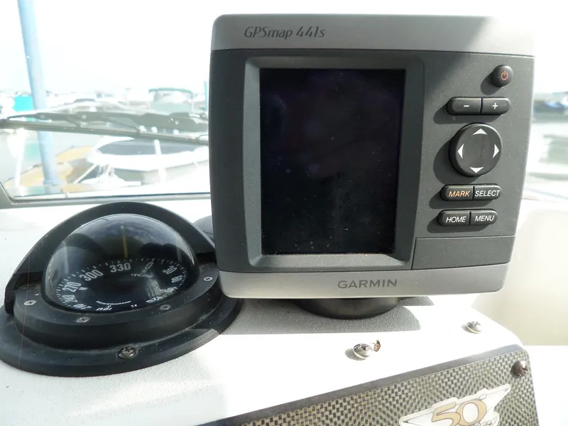 Slide: The Image of 2005 Seaswirl Striper boat dashboard with Garmin GPSmap 441s and compass. - 19