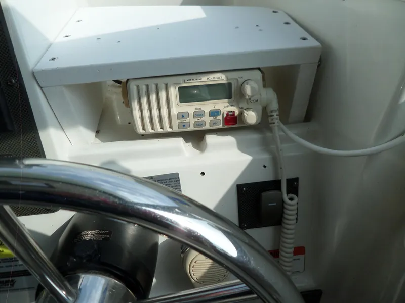 Slide: The Image of 2005 Seaswirl Striper boat dashboard with VHF marine radio and steering wheel. - 21