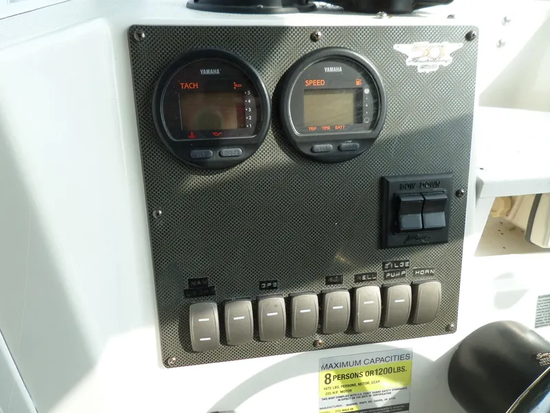 Slide: The Image of 2005 Seaswirl Striper dashboard with Yamaha tachometer and speedometer gauges. - 22