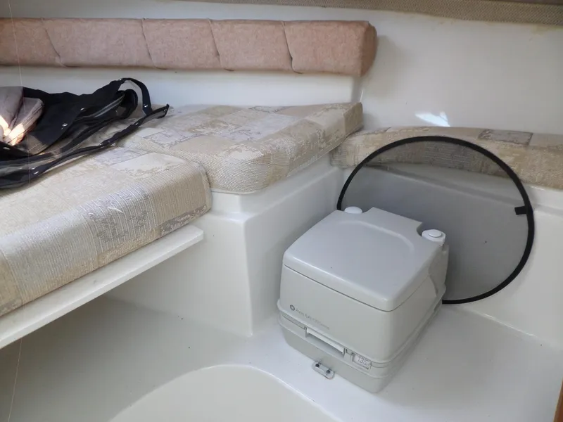 Slide: The Image of 2005 Seaswirl Striper interior with seating and portable toilet. - 25